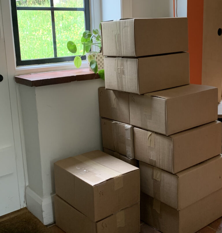 Stack of boxes containing The Storytelling Manual for Architects